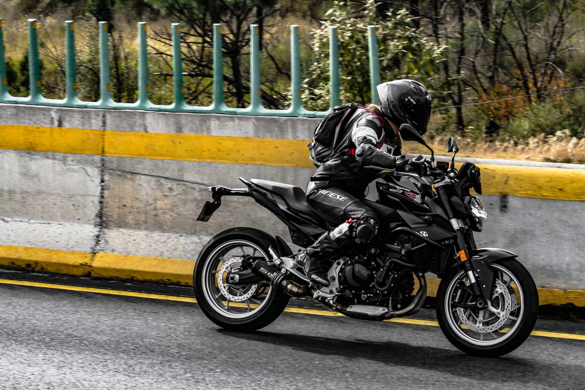 Motorcyclist in full gear riding on the open road